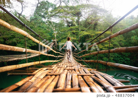 Young woman on bamboo bridge in Bohol, Philippines 48837004