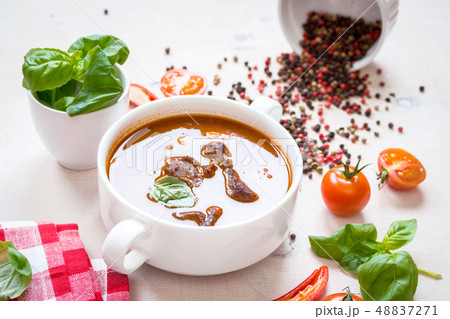 Tomato soup with meat in a white bowl on a white wooden background Tomato soup with meat in a white bowl on a white wooden background 48837271
