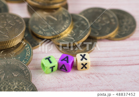 colorful cube with word TAX on wooden table 48837452