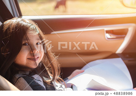 Cute Little Asian Girl sitting on the car. 48838986