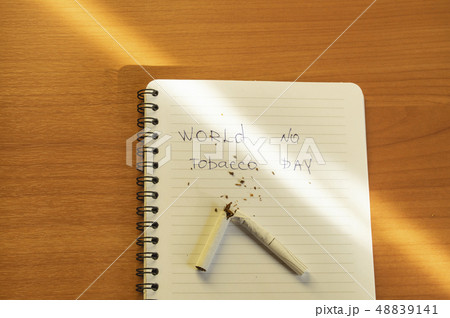 Flat lay, cigarettes and the inscription world no tobacco day written in a notebook, a healthy Flat lay, cigarettes and the inscription world no tobacco day written in a notebook, a healthy 48839141