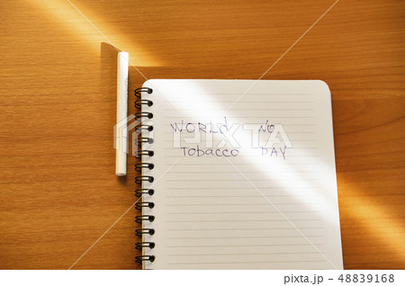 Flat lay, cigarettes and the inscription world no tobacco day written in a notebook, a healthy Flat lay, cigarettes and the inscription world no tobacco day written in a notebook, a healthy 48839168