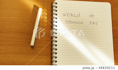 Flat lay, cigarettes and the inscription world no tobacco day written in a notebook, a healthy Flat lay, cigarettes and the inscription world no tobacco day written in a notebook, a healthy 48839211