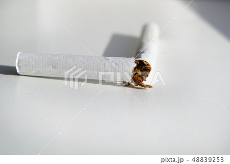 Broken cigarette on white background, Smoking cessation concept, minimalism style, selective focus Broken cigarette on white background, Smoking cessation concept, minimalism style, selective focus 48839253