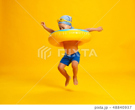 happy child boy in swimsuit with swimming ring 48840937