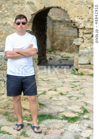 A young man in a white T-shirt and sunglasses A young man in a white T-shirt and sunglasses 48842910