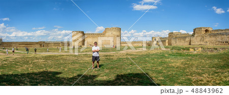 A man in shorts and a T-shirt stands on the 48843962