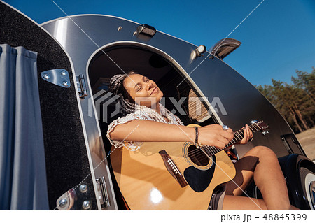 African-American musician feeling amazing playing the guitar 48845399