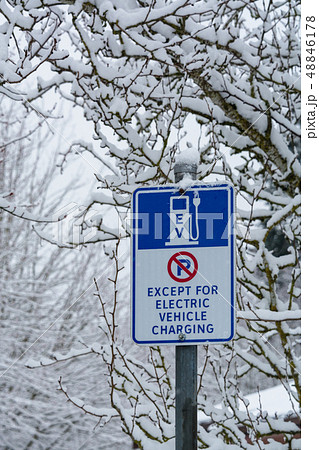 Road sign with EV charging station on snow background 48846178