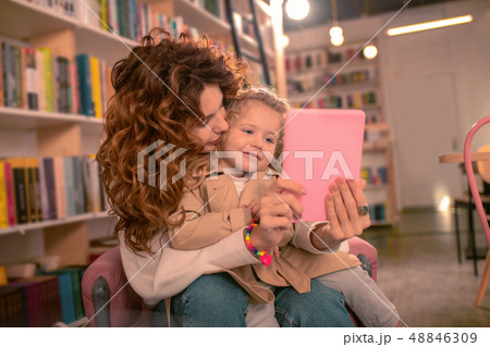 Positive delighted blonde girl leaning on her mother 48846309