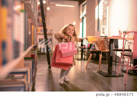 Happy little girl running with shopping bags Happy little girl running with shopping bags 48846375