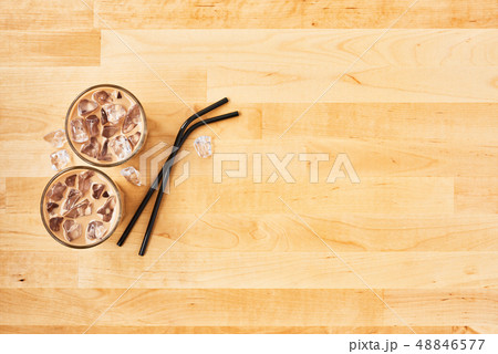 Iced coffee in tall glass with black metal straws Iced coffee in tall glass with black metal straws 48846577