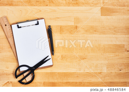 Cardboard clipboard and pen on wooden background Cardboard clipboard and pen on wooden background 48846584