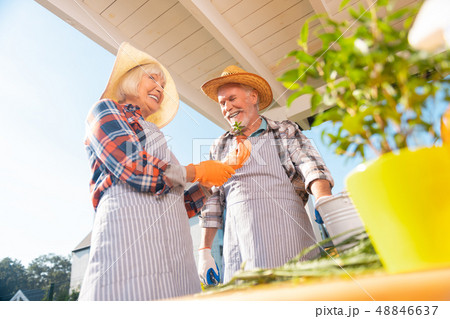 Couple of retired man and woman wearing nice straw hats smiling broadly Couple of retired man and woman wearing nice straw hats smiling broadly 48846637