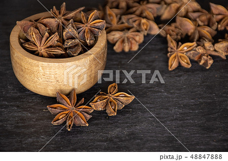 Dry brown star anise fruit on grey stone Dry brown star anise fruit on grey stone 48847888
