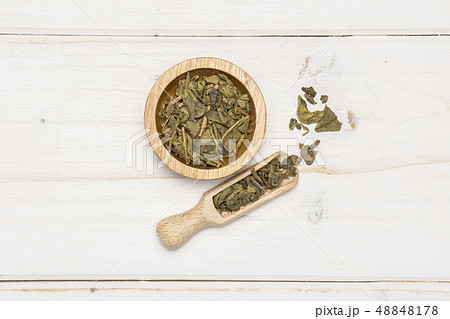 Dry green tea on grey wood 48848178
