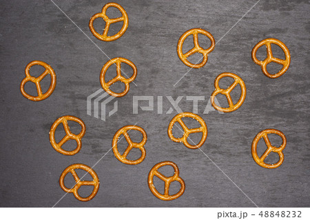 Mini salted pretzels on grey stone 48848232