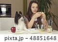 Teen girl with dog Papillon prepare cookies, knead the dough 48851648