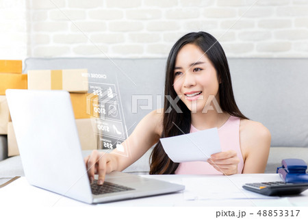 Young woman online seller working on laptop 48853317