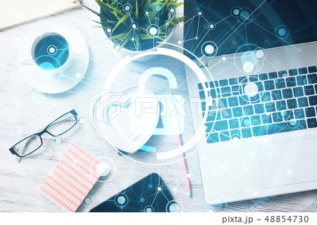 Business workplace with laptop coffee cup and security concept on screen 48854730