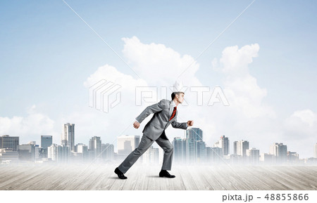 King businessman in elegant suit running and modern cityscape at background 48855866