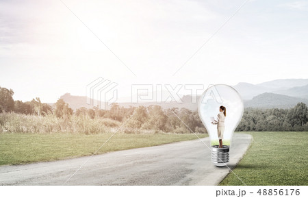 Businesswoman inside light bulb Businesswoman inside light bulb 48856176