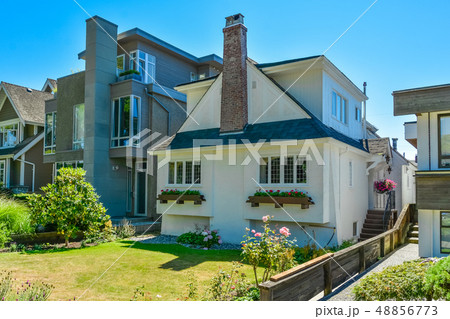 Ancient and modern residential houses side by side on the street Ancient and modern residential houses side by side on the street 48856773