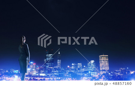 Woman looking at night city 48857160