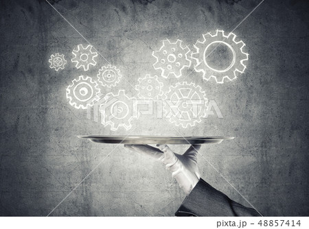 Waiter hand with empty silver tray and drawn gears concept 48857414