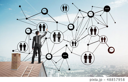 Businessman on house roof presenting networking and connection concept. Mixed media Businessman on house roof presenting networking and connection concept. Mixed media 48857958