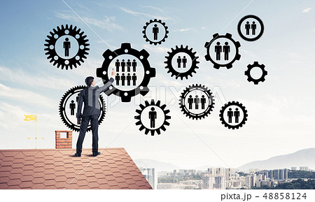 Businessman on house roof presenting teamwork and connection con 48858124