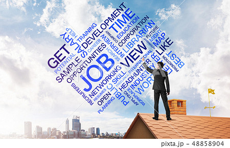 Young businessman standing on house roof and writing leadership skill concept. Mixed media 48858904