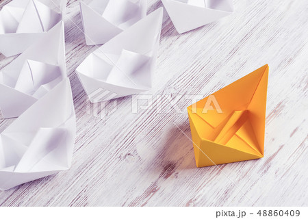 Business leadership concept with white and color paper boats on 48860409