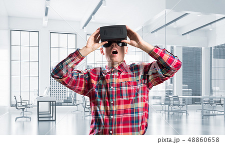 Concept of modern entertaining technologies with man wearing virtual reality mask 48860658