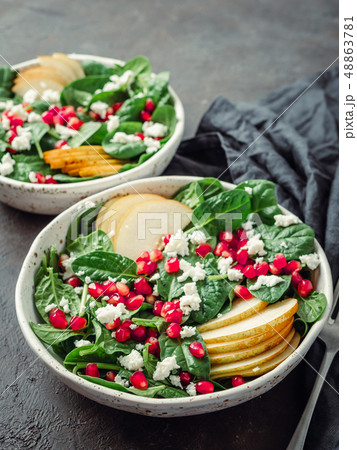 Vegan salad bowl with spinach, pear, pomegranate, cheese 48863781