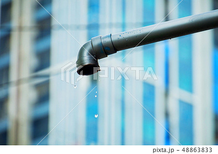 Water droplets flow out from the steel sewer. 48863833