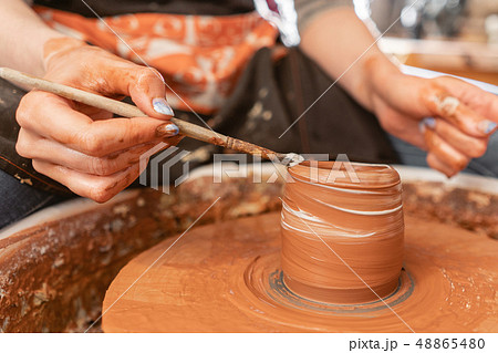 Craftsman hands making pottery bowl. Woman working on potter wheel . Family business shop sculpts 48865480