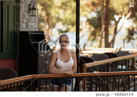 Sensual woman in swimwear near pillar 48866554