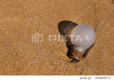Ecology: beach discoveries - old rusted bulb Ecology: beach discoveries - old rusted bulb 48868072