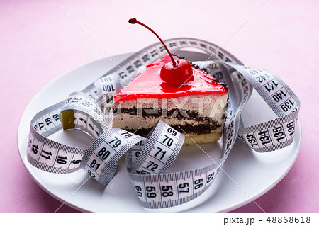 pink background with delicious cakes and measure tape 48868618