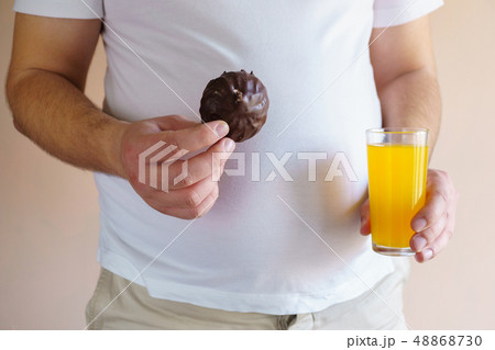 overweight man with unhealthy fattening food 48868730