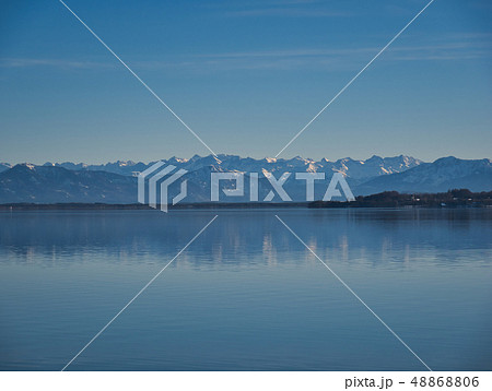 The mountains are reflected in the calm water The mountains are reflected in the calm water 48868806