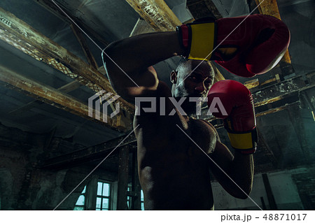 Hand of boxer over black background. Strength, attack and motion concept Hand of boxer over black background. Strength, attack and motion concept 48871017