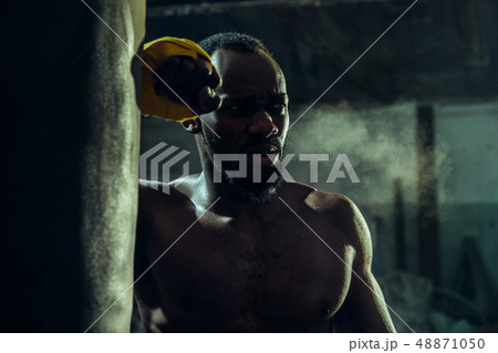 Hand of boxer over black background. Strength, attack and motion concept 48871050