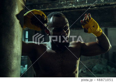 Hand of boxer over black background. Strength, attack and motion concept 48871051