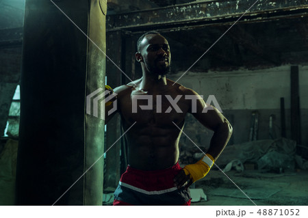 Hand of boxer over black background. Strength, attack and motion concept 48871052