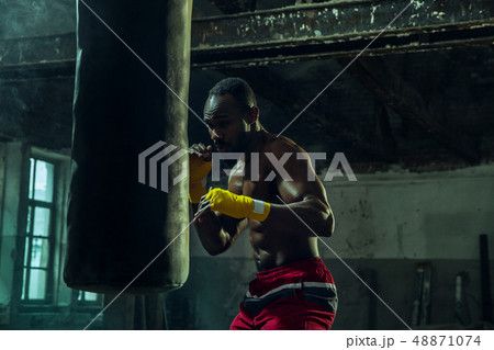 Hand of boxer over black background. Strength, attack and motion concept Hand of boxer over black background. Strength, attack and motion concept 48871074