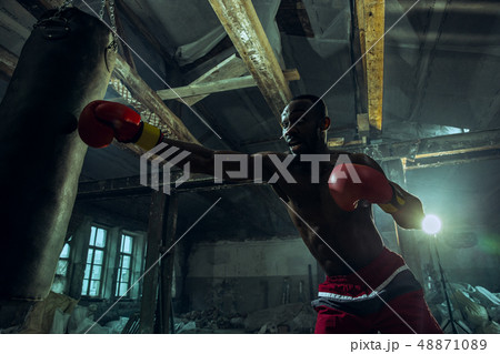 Hand of boxer over black background. Strength, attack and motion concept 48871089