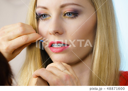 Woman getting make up done by artist 48871600