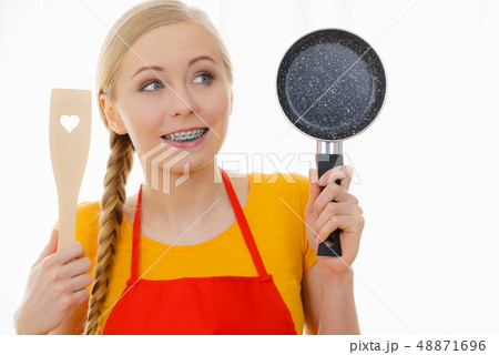 Woman holding cooking pan and spatula 48871696